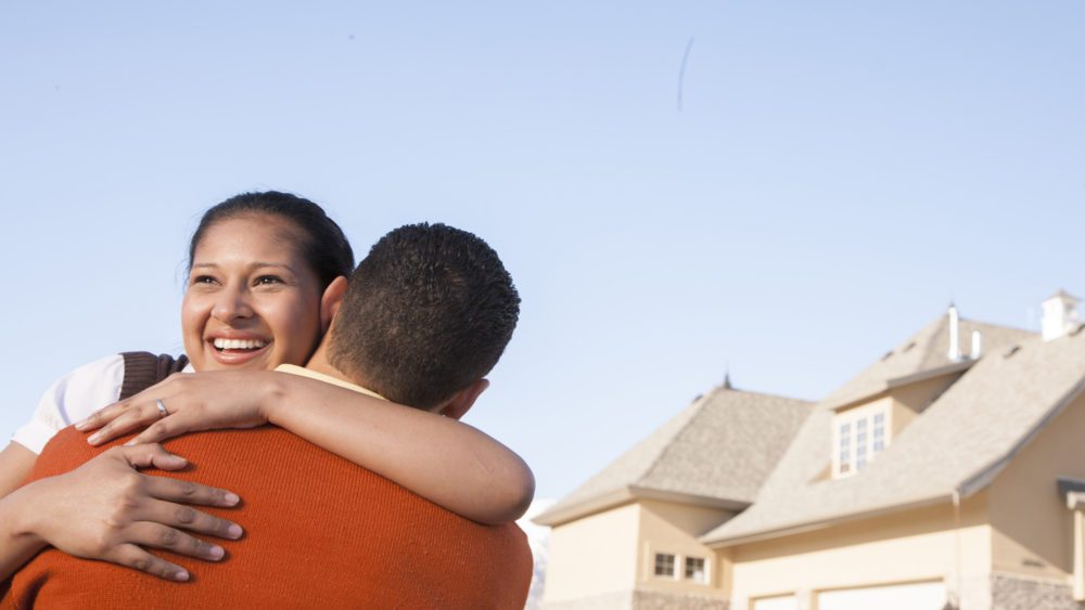 couple in front of new home true concept title national agency