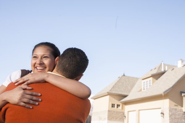 couple in front of new home true concept title national agency