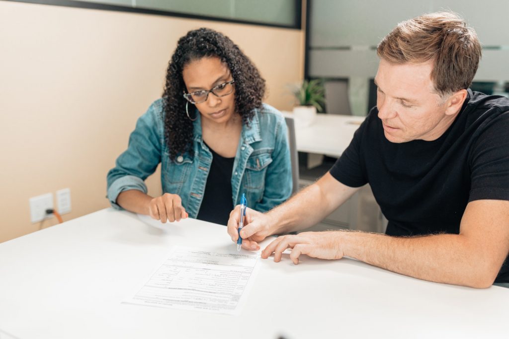 man and woman signing papers